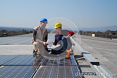 Young engineer girl and skilled worker on a roof Stock Photo