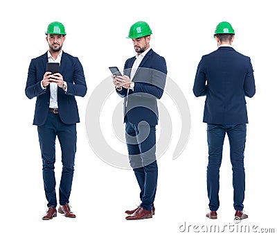 Young engineer in helmet checking the processes in tablet, isolated Stock Photo