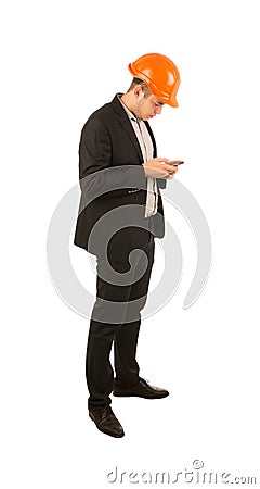 Young engineer using his mobile phone to text Stock Photo