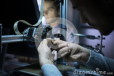 Young engineer working on a 3D printer Stock Photo