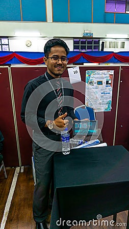 Young engineering student presenting his product named I-BOX at the Final Year Project exhibition Editorial Stock Photo