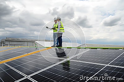 Young Engineers and Specialist Technicians Discuss and Check Quality of Installing Solar Photovoltaic Panels and Use App Stock Photo