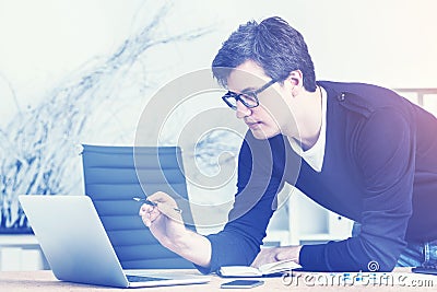 Young enterpreneur in glasses working, toned Stock Photo