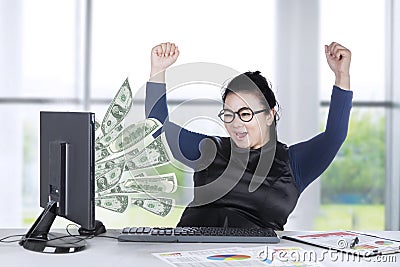 Young entrepreneur looking money on screen Stock Photo