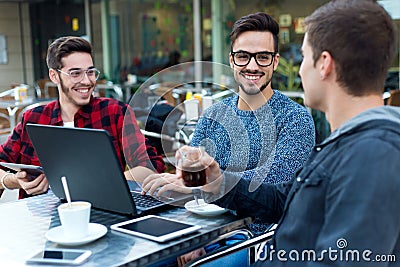 Young entrepreneurs working at coffee bar. Stock Photo