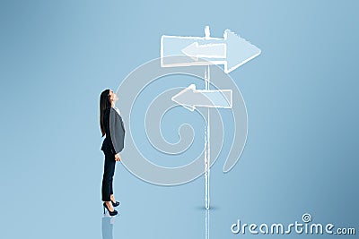 Young european business woman thinking which path to choose on blue background with sign sketch. Different direction concept Stock Photo