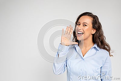 Young European woman screams, hand over mouth Stock Photo