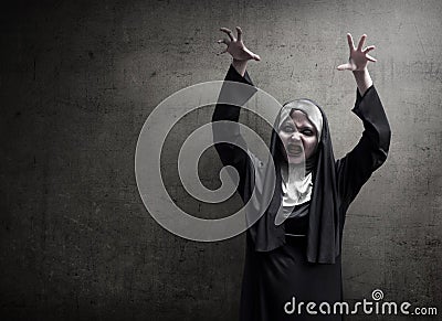 Young evil asian woman nun scare Stock Photo