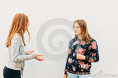 Young expressive girls having active conversation Stock Photo