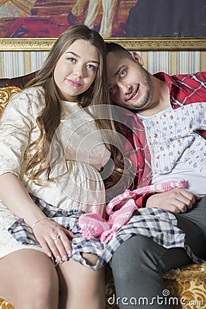 Young family in anticipation of the birth of the child considers Stock Photo