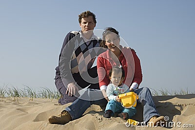 Young family at the beach Stock Photo