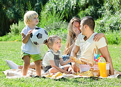 Young family with children having picnic outdoor Stock Photo