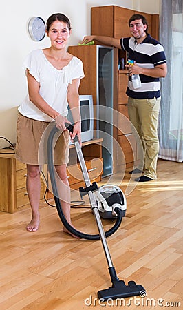 Young family couple doing regular clean-up Stock Photo