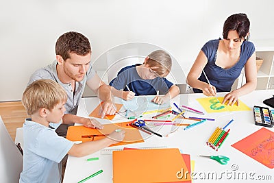 Young family drawing with colorful pencils Stock Photo