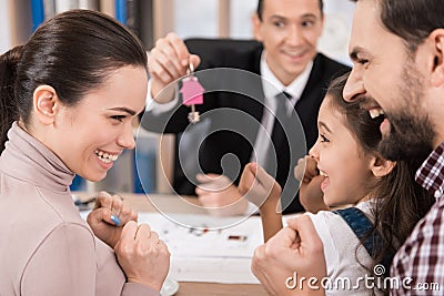 Young family is happy to buy new house in office of realtor. Buying house. House for sale. Stock Photo