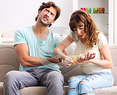 Young family helping each other after injury Stock Photo