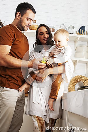 Young family with little cute son on kitchen in morning happy smiling, lifestyle people concept Stock Photo