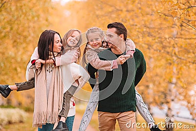 Portrait of happy family of four in autumn day Stock Photo