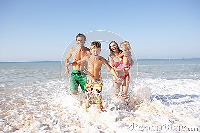 Young family play on beach Stock Photo