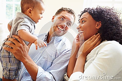 Young Family Playing With Happy Baby Son At Home Stock Photo