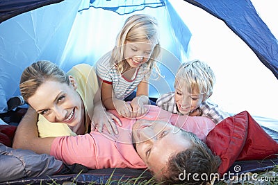 Young family playing in tent Stock Photo