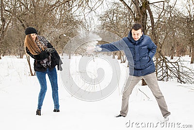 The young family plays winter wood on snow Stock Photo