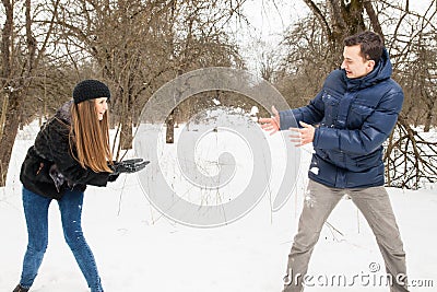 The young family plays winter wood on snow Stock Photo