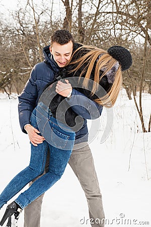 The young family plays winter wood on snow Stock Photo