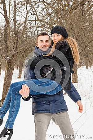 The young family plays winter wood on snow Stock Photo