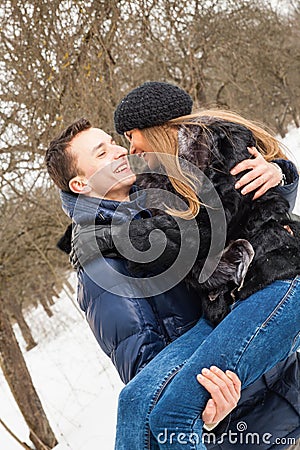 The young family plays winter wood on snow Stock Photo