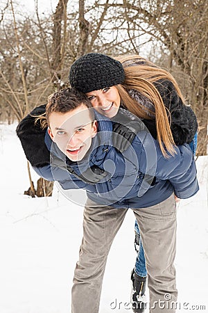 The young family plays winter wood on snow Stock Photo