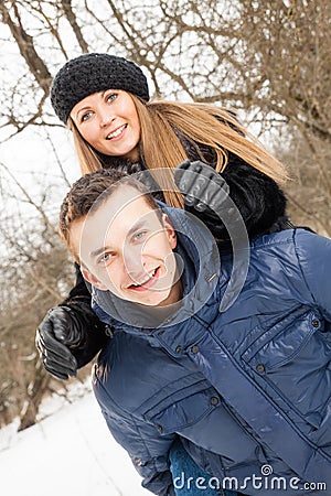 The young family plays winter wood on snow Stock Photo