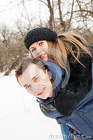 The young family plays winter wood on snow Stock Photo