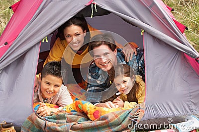 Young Family Relaxing Inside Tent Stock Photo