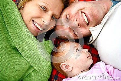 Young family on rug Stock Photo