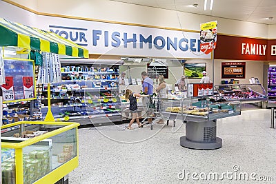 Young family shopping at the fishmongers counter in Morrisons supermarket store. Editorial Stock Photo