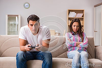 The young family suffering from computer games addiction Stock Photo