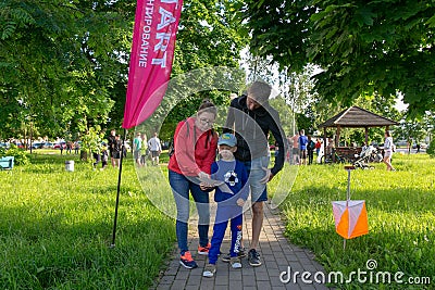 A young family of three people at the start of the route Editorial Stock Photo