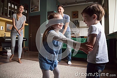 Young family with two children playing hide-and-seek Stock Photo
