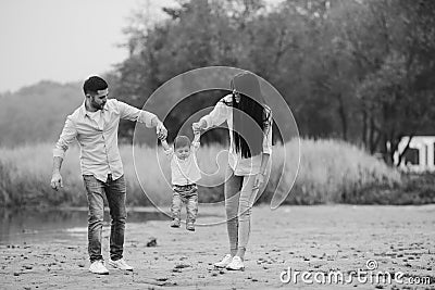 Young family walking at the beach Stock Photo