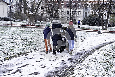 Young Family walking in park in first winter snow, The Czech Republic Editorial Stock Photo