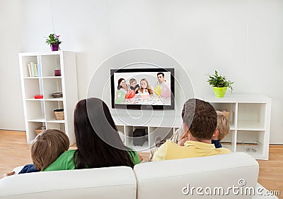 Young family watching TV Stock Photo