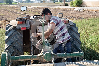 Young farmer preparing the farm tools to start the cultivation of the orchard Stock Photo