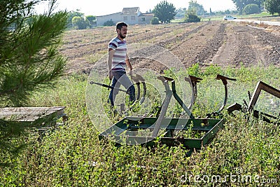 Young farmer preparing the farm tools to start the cultivation of the orchard Stock Photo