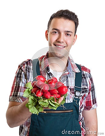 Young farmer showing red radishes Stock Photo