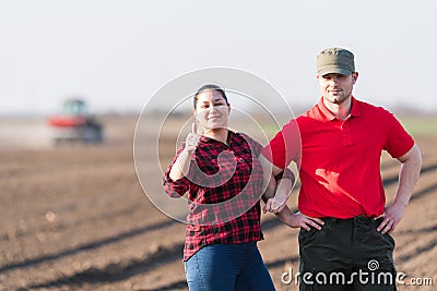 Young farmers examing planted wheat fields Stock Photo