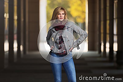 Young fashion blonde woman in checked plaid blazer and snood scarf Stock Photo