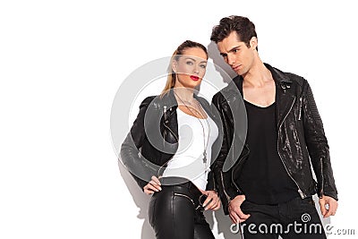 Young fashion couple in leather clothes posing in studio Stock Photo