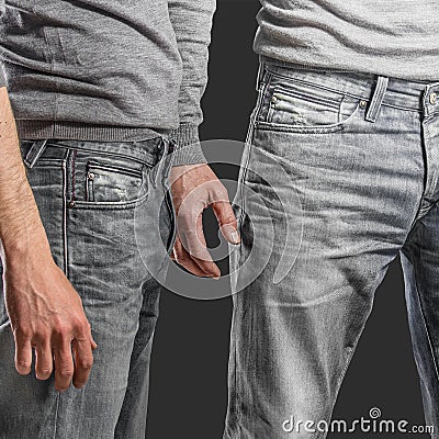 Young fashion man's legs in jeans and grey pullover Stock Photo