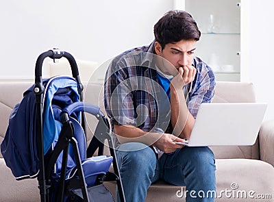 Young father assembling baby pram at home Stock Photo